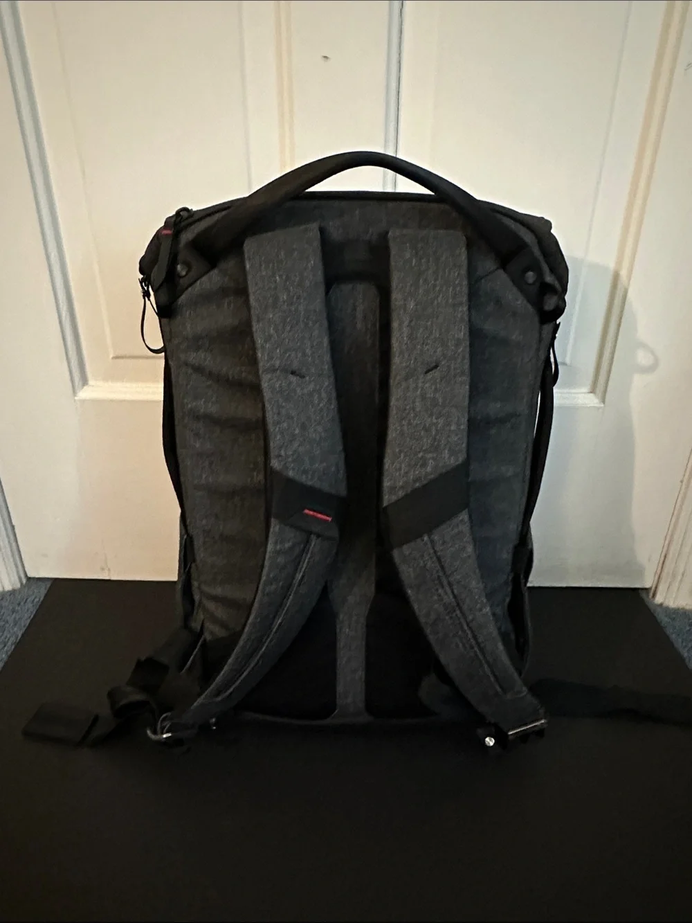 Peak Design Dark Gray Everyday Backpack with Red Accent.